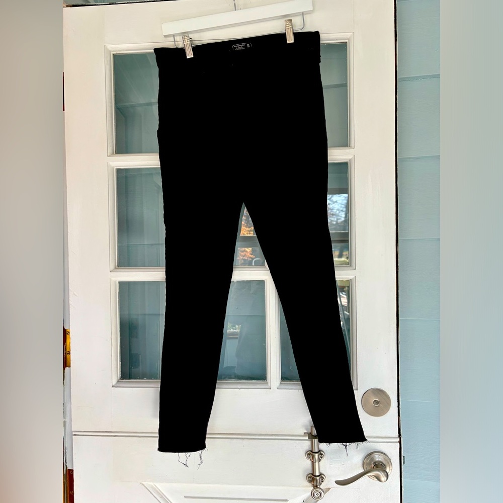 Abercrombie and Fitch ultra high-rise black jeans with frayed hem.
